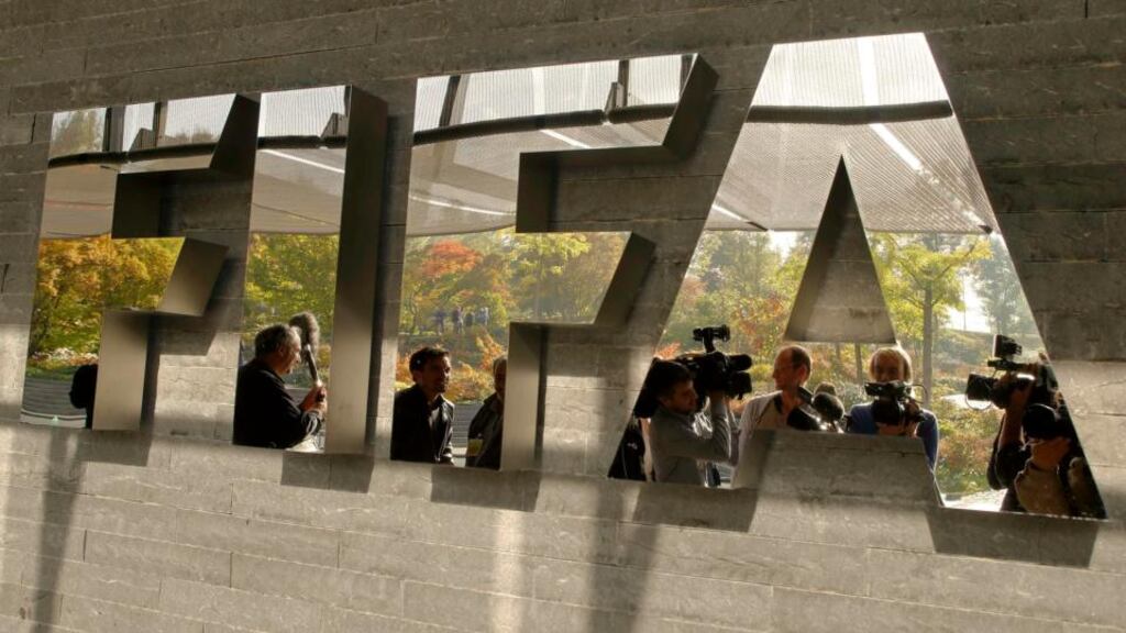 Journalists are reflected in a logo at the Fifa headquarters in Zurich. Photograph: Arnd Wiegmann/Reuters