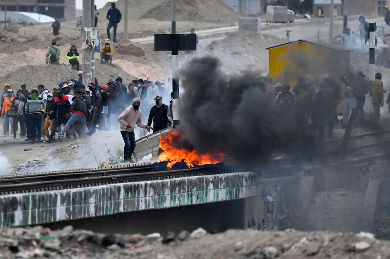 Demonstrators light a fire at the Añashuayco bridge, near the Rodríguez Ballón airport, in Arequipa, Peru, during a protest against the government on Friday. Photograph: Diego Ramos/AFP via Getty