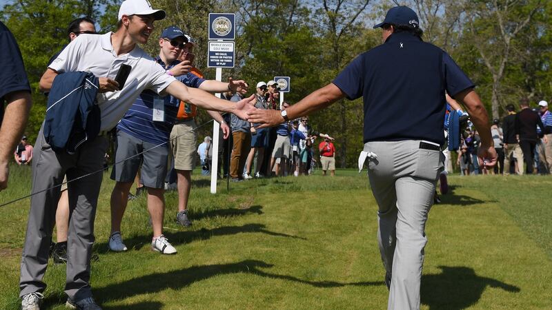 Phil Mickelson with a fan during the second round of the US PGA Championship. Photograph: Ross Kinnaird/Getty