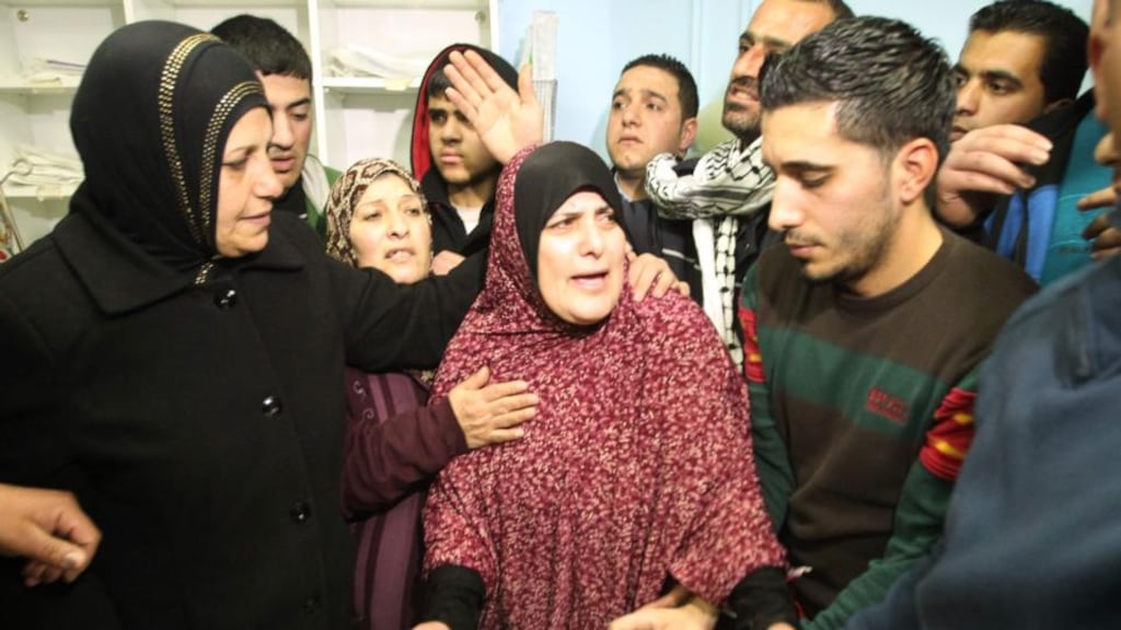 The mother (centre), friends and relatives of Omar Maddi, at  al-Mizan hospital in the West Bank city of Hebron. Photograph: Hazem Bader/AFP/Getty Images