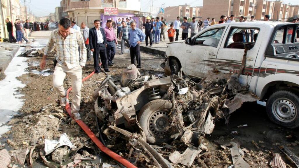 Iraqi security personnel inspect the site of a bomb attack in Kirkuk, 250km north of Baghdad. Photograph: Ako Rasheed/Reuters