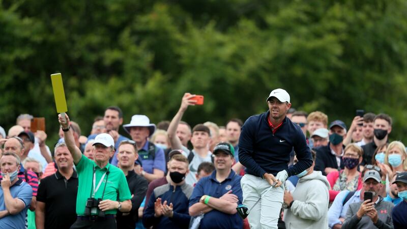 Rory McIlroy keeps a close eye on a tee shot in the second round.