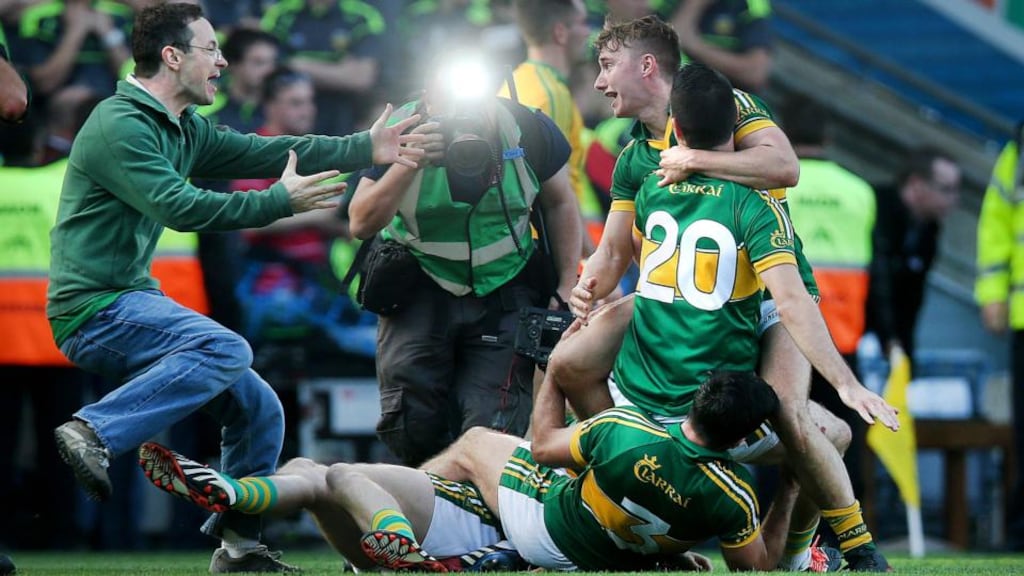 In the spotlight: Kerry players celebrateas a supporter rushes onto the pitch after the final whistle in Croke Park yesterday. Photograph: Donall Farmer/Inpho