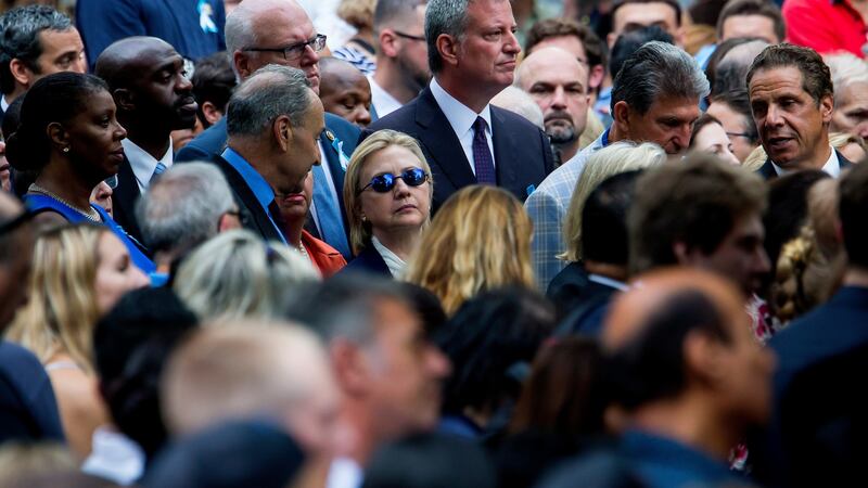 Hillary Clinton flanked by Senator Chuck Schumer (D-N.Y.), left, and Mayor Bill de Blasio during a ceremony to mark the 15th anniversary of the 9/11 attacks in lower Manhattan on Sunday. Photograph: Eric Thayer/The New York Times