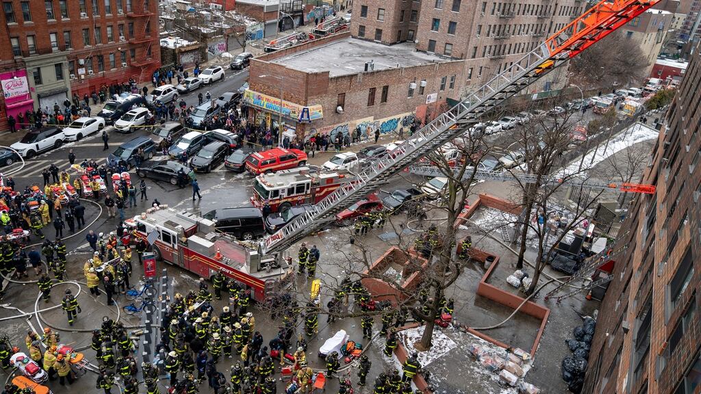 About 200 firefighters respond to the scene of a fire in a high-rise building in the Tremont section of the Bronx on Sunday. Photograph: New York Times