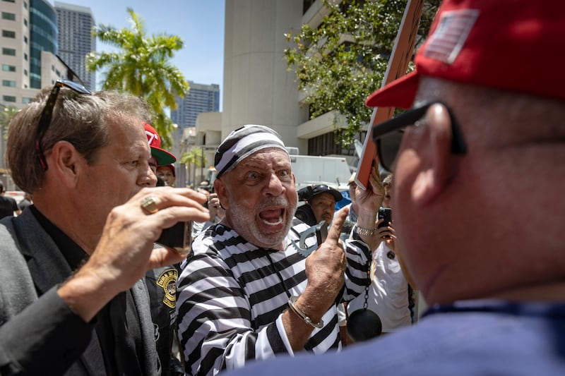 Domenic Santana is surrounded by Trump supporters outside the Wilkie D Ferguson Jr US Courthouse in Miami. He said some members of his family have been caught up in the "Trump cult". Photograph: Christian Monterrosa/New York Times.