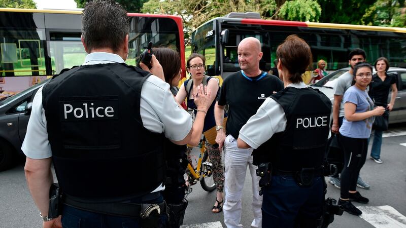 Police officers speak with parents of children at a school in Liege after a man killed three people including two policemen. Photograph: AFP/Getty Images