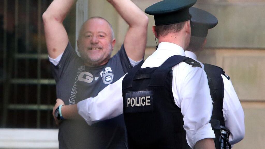 Kieran McLaughlin (58) gestures to family and friends, as he leaves Derry Magistrates court in Derry, he was arrested by police after a week long search,and charged with the murder of Barry McCrory. Photograph: PA