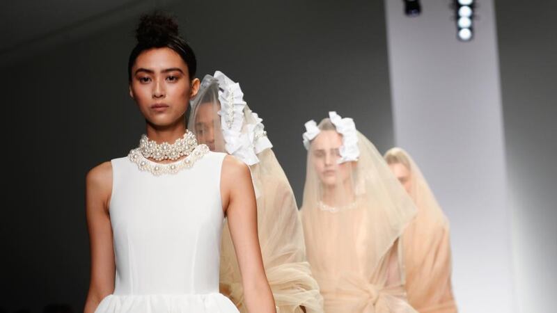 Models present creations from the Simone Rocha Spring/Summer 2014 collection during London Fashion Week yesterday.