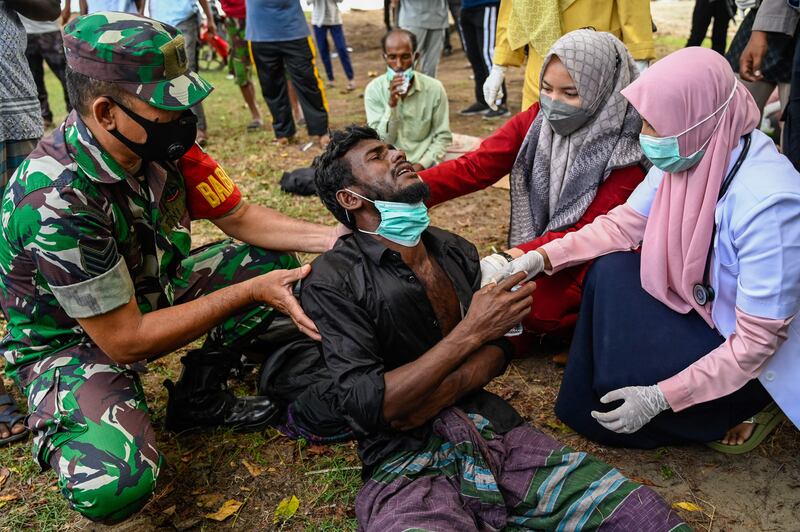 Health workers check a Rohingya refugee who arrived by boat to Krueng Raya in Indonesia's Aceh province on Christmas day. Photograph: Getty Images