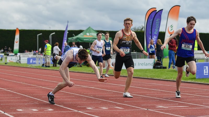 Conor O’Carroll of St Colman’s Newry (left) trips and dives for the line to to win the intermediate boys’ 400m  during the Irish Life Health All-Ireland Schools Track and Field Championships in Tullamore. Photograph: Sam Barnes/Sportsfile