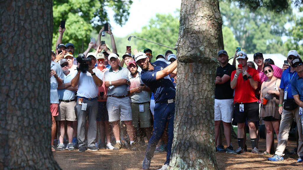Dustin Johnson plays from the trees on his way to winning the FedEx St Jude Clasic in Memphis. Photo: Getty Images