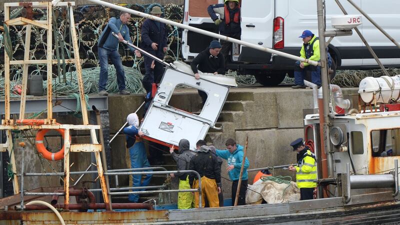 Debris from a Coast Guard helicopter is taken from a trawler at the pier in Blacksod, Co Mayo. Photograph: Dara Mac Dónaill