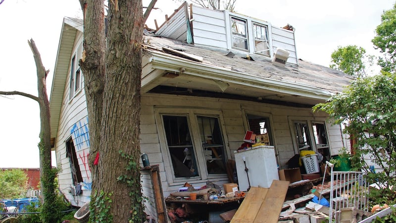 Trees in front of a house in Dayton prevented the tornado from lifting it entirely. Photograph: Stephen Starr