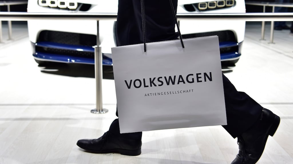 A Volkswagen shareholder walks past a car on display during German carmaker Volkswagen shareholders’ annual general meeting on June 22, 2016 in Hanover. Photograph: AFP/Getty Images