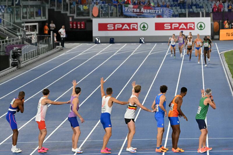 Adeleke comes down the home straight in first place, Barr in lane one waiting for the baton. Photograph: Andrea Solaro/ Getty Images
