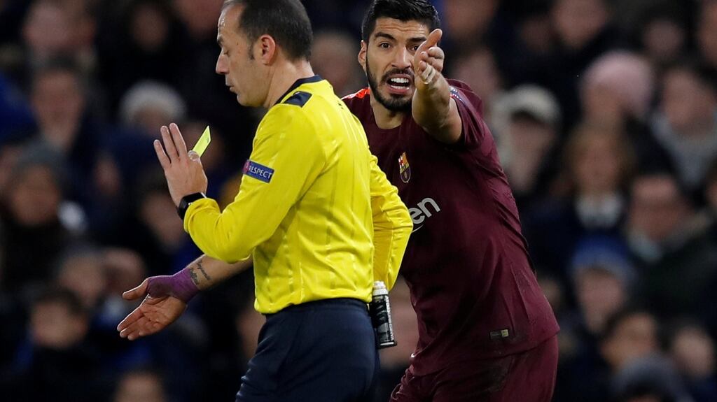 Referee Cuneyt Cakir shows a yellow card to an indignant Luiz Suarez during Barcelona’s Champions League clash against Chelsea at Stamford Bridge. Photograph: Eddie Keogh/Reuters