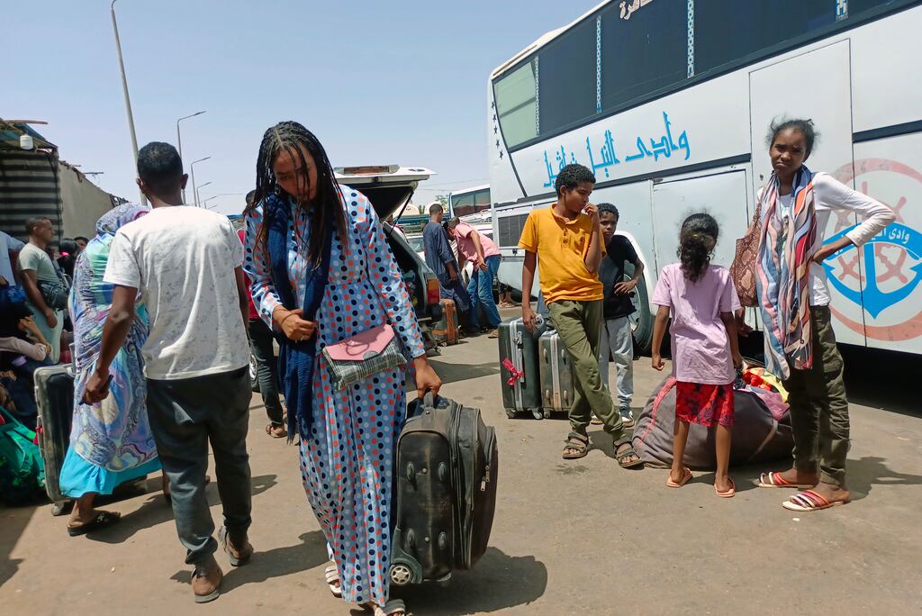 Passengers fleeing from Sudan arrive at Wadi Karkar bus station in Aswan, Egypt. Photograph: EPA