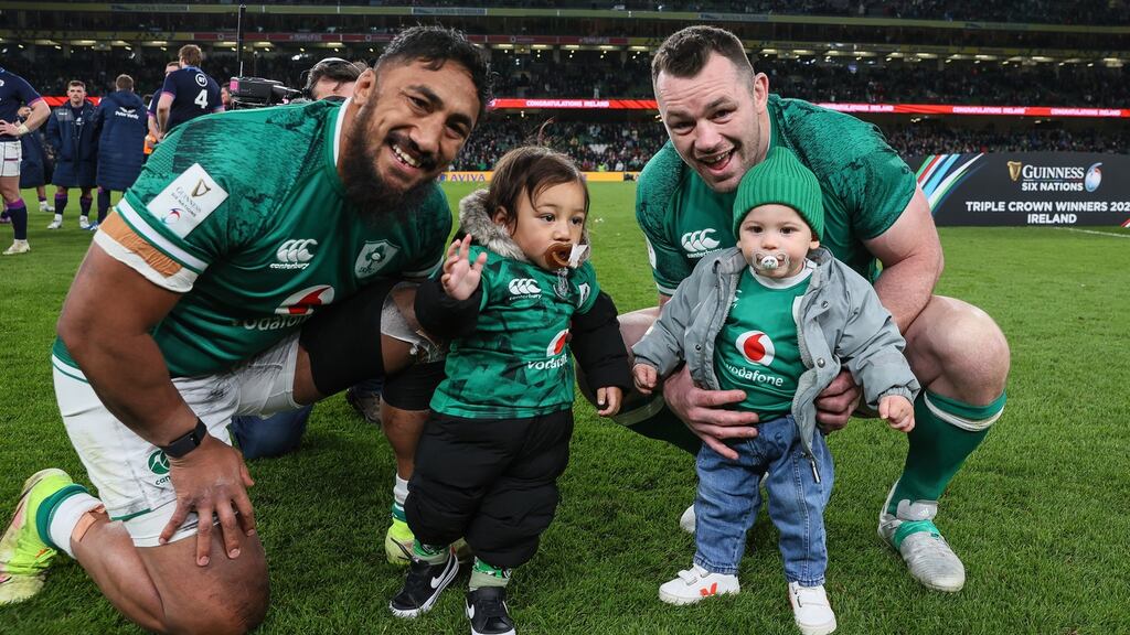 Ireland’s Bundee Aki and Cian Healy celebrate winning the Triple Crown with their sons Andronicus Junior Papamau and Beau. Photograph: Billy Stickland/Inpho