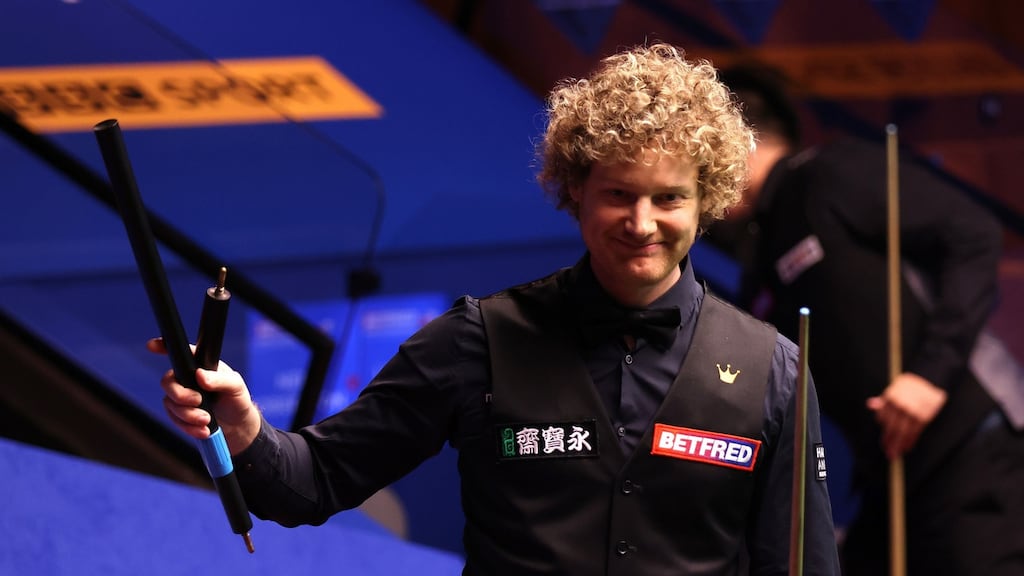 Neil Robertson celebrates victory against Liang Wenbo at The Crucible. Photograph: PA