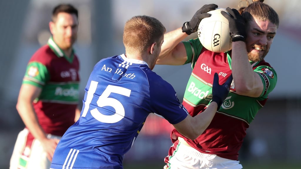 Coleraine’s Ruairi Mooney is challenged by Scotstown’s Ciaran McGoldrick. Photograph: Declan Roughan/Inpho