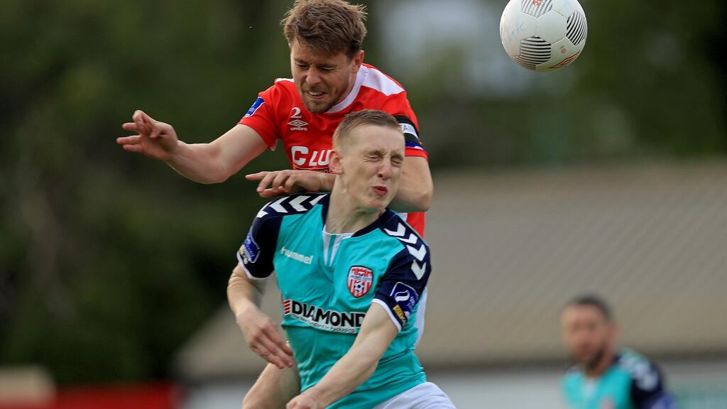 St Patrick’s Athletic’s Ger O’Brien and Derry City’s Ronan Curtis contest a high ball at Richmond Park. Photograph: Donall Farmer/Inpho