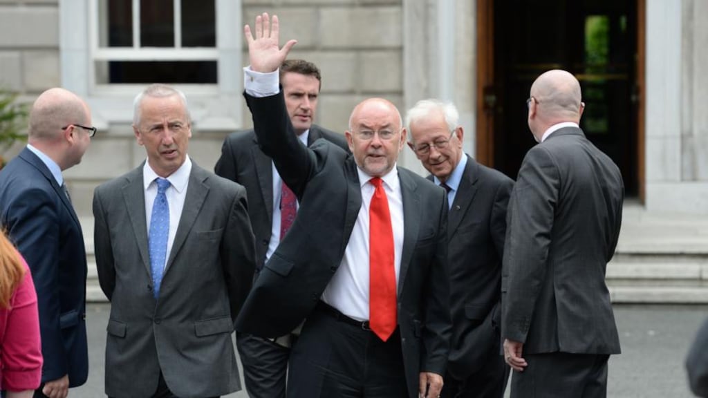 Minister for Education Ruairí Quinn waves after announcing he would resign from Cabinet in next week’s reshuffle, at Leinster House, Dublin yesterday. Photograph: Dara Mac Dónaill