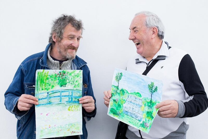 Donal Moran and John Adam with their paintings.