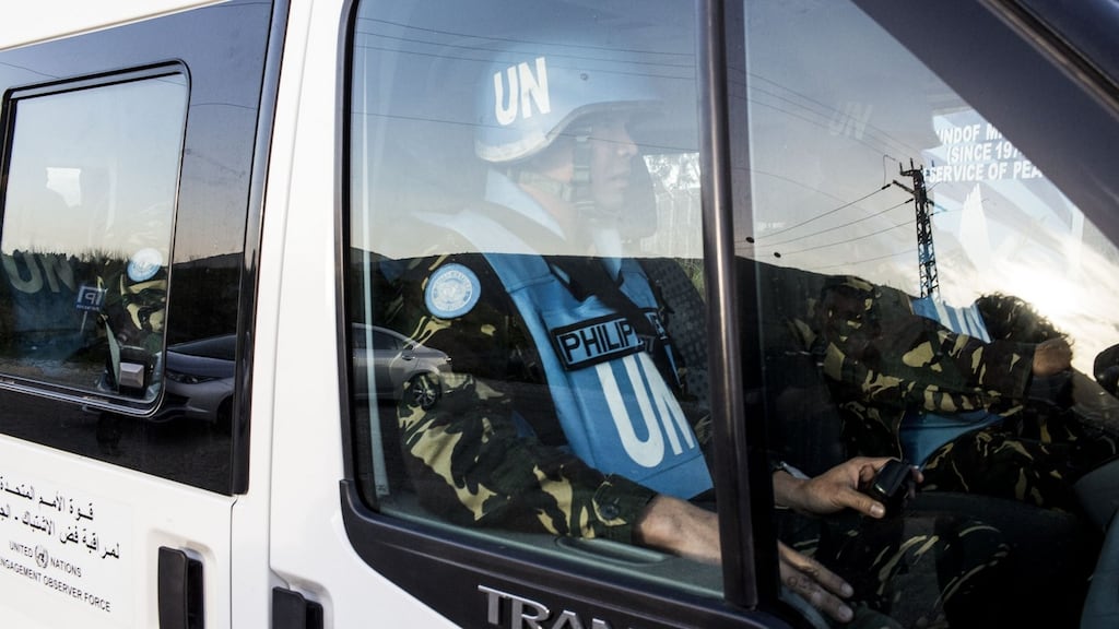 Filipino United Nations Disengagement Observer Force (UNDOF) personnel drive to the UNDOF camp in the Golan Heights region. Photograph: Ilia Yefimovich/Getty Images