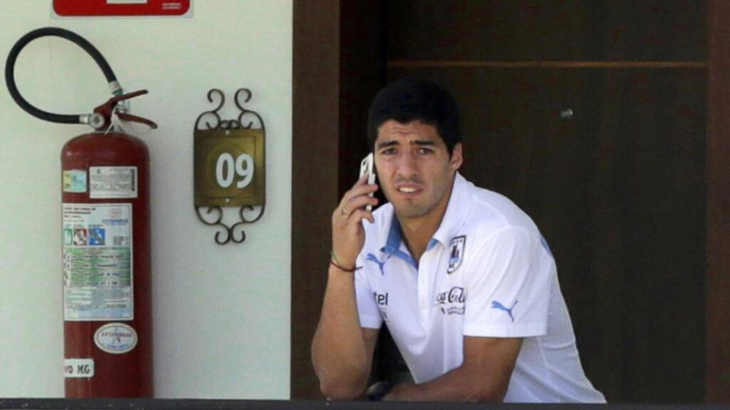 Uruguay striker Luis Suarez talks on the phone at his team’s hotel in Sete Lagoas, near Belo Horizonte, on Monday. The Liverpool player says he is fully fit for Thursday’s game against England. Photograph: Lavandeira Jr/EPA
