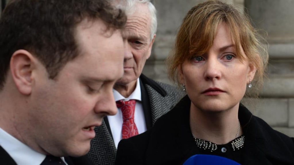 Roberta Dodd looks on as her husband David reads a statement outside the High Court today after a maternity hospital apologised to the couple over the death of their baby son Senan Dodd. Photograph: Dara Mac Dónaill/The Irish Times