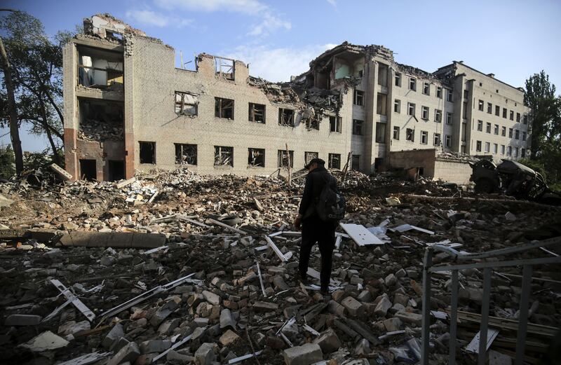 A local man walks through rubble in the Zaytseve village of the Donetsk region, Ukraine. Photograph: EPA