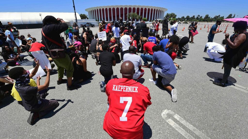 ‘The right to kneel for justice’: Supporters of quarterback Colin Kaepernick have called for a boycott of NFL games and merchandise purchases. Photograph: Frederic J Brown/AFP via Getty Images