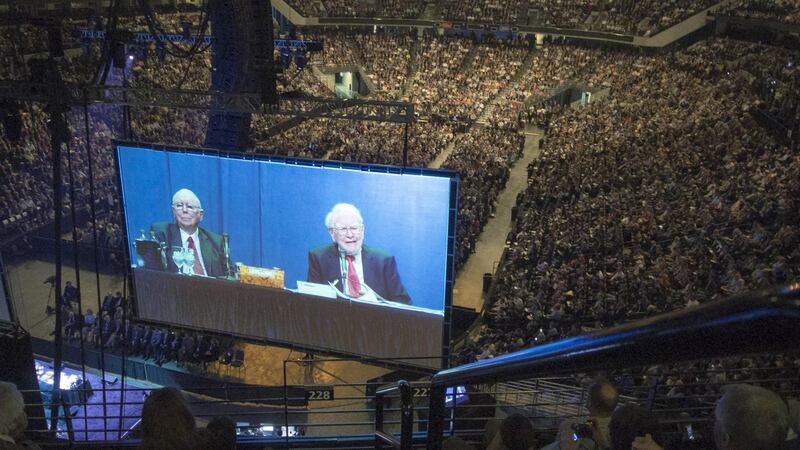 Berkshire Hathaway chairman and CEO Warren Buffett, right, and his vice charman Charlie Munger are seen on a giant screen during a Berkshire Hathaway shareholders meeting in Omaha, Nebraska.