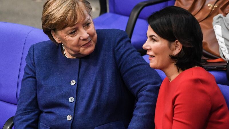 German chancellor Angela Merkel talks to German Green Party’s co-leader Annalena Baerbock. Photograph: Filip Singer/EPA
