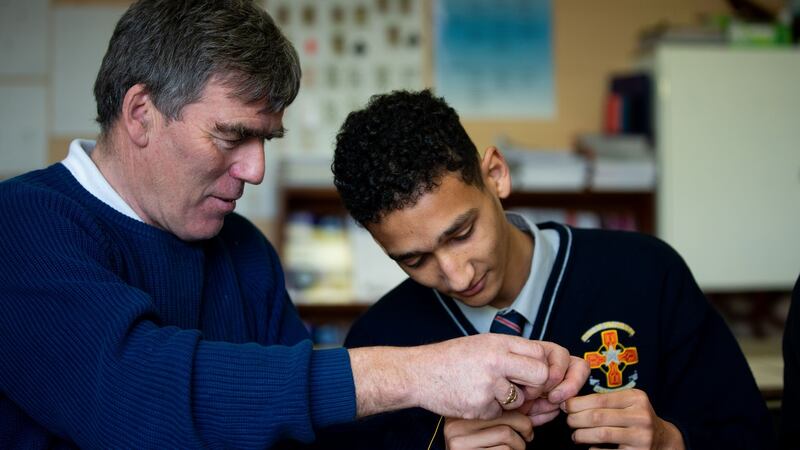Mohamed Eldib is shown how to tread a hook by Ian Daly of Fishing for Futures. Photograph: Tom Honan