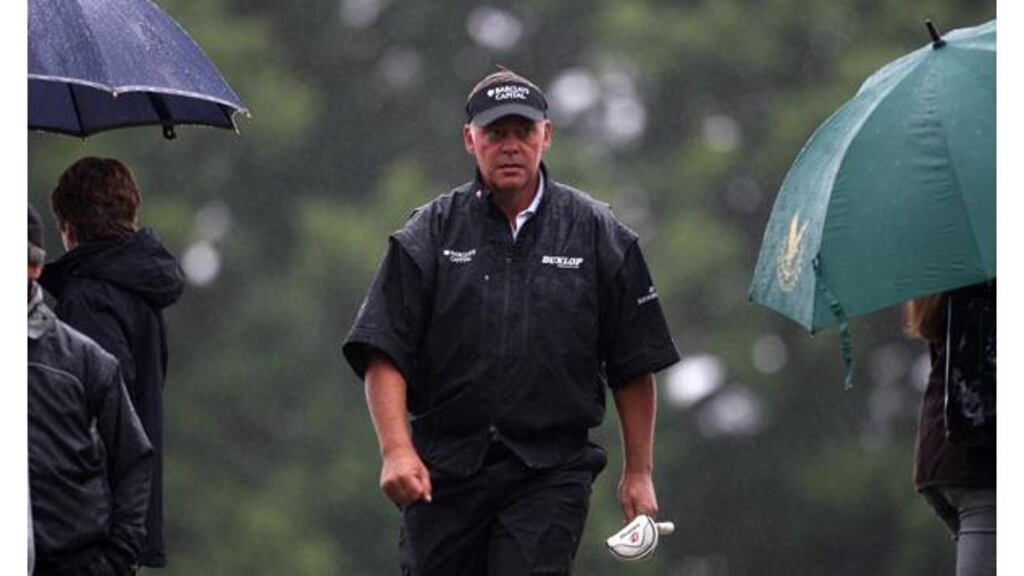 Darren Clarke makes his way to the 10th green after resuming his challenge at a wet and windy Loch Lomond this morning. Photograph: Lynne Cameron/PA