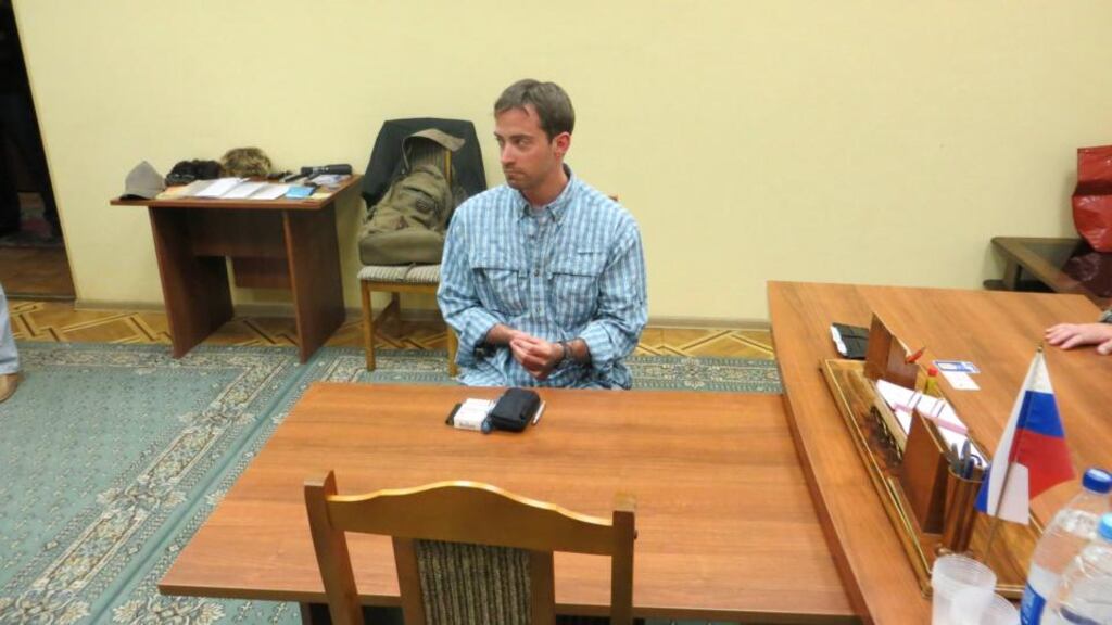 A man named as Ryan Fogle by the Russian Federal Security Service, sits in the receiving office of the Federal Security Service in Moscow