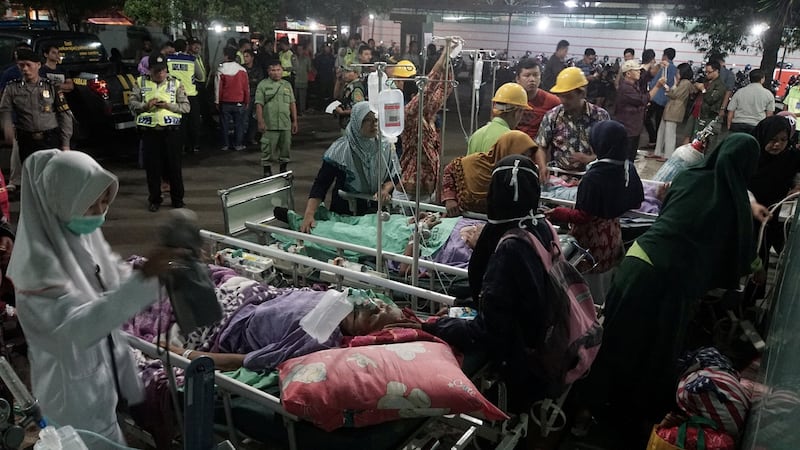 Patients are evacuated to a car park outside a damaged hospital after an earthquake hit Banyumas, Central Java, Indonesia. Photograph: Antara Foto/Idhad Zakaria/via Reuters