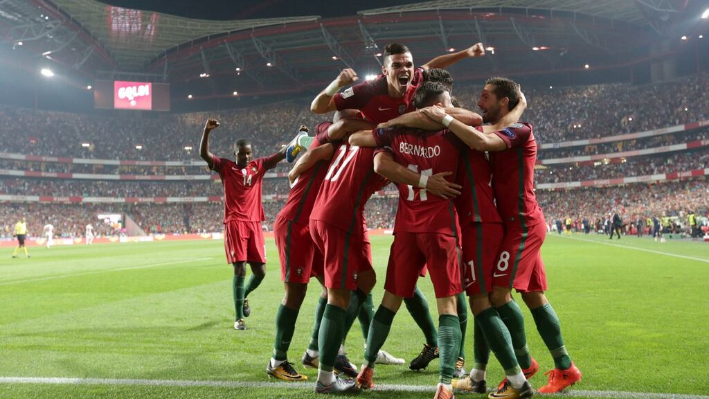 Portugal celebrate after Andre Silva’s strike gave them a 2-0 lead against Switzerland. Photograph: Armando Franca/AP