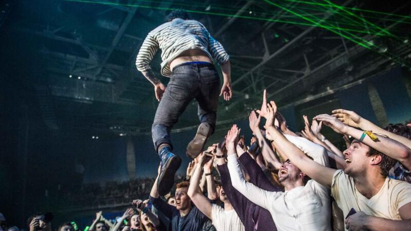 Yannis Philippakis dives into the crowd during Foals’ concert in the 3Arena in Dublin. Photograph: Ruth Medjber