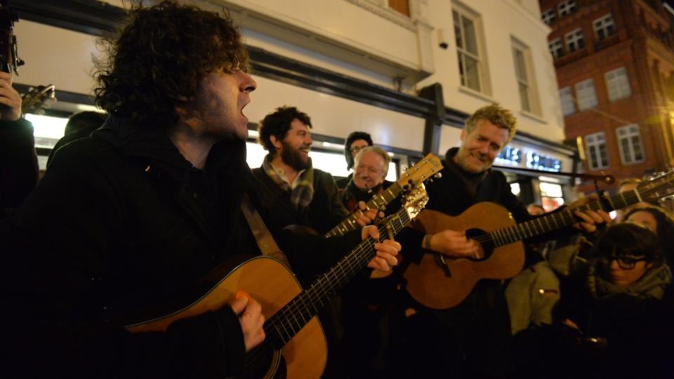 Paddy Casey and Glen Hansard enjoy the Grafton Street Christmas Eve busk. Photograph: Alan Betson / The Irish Times