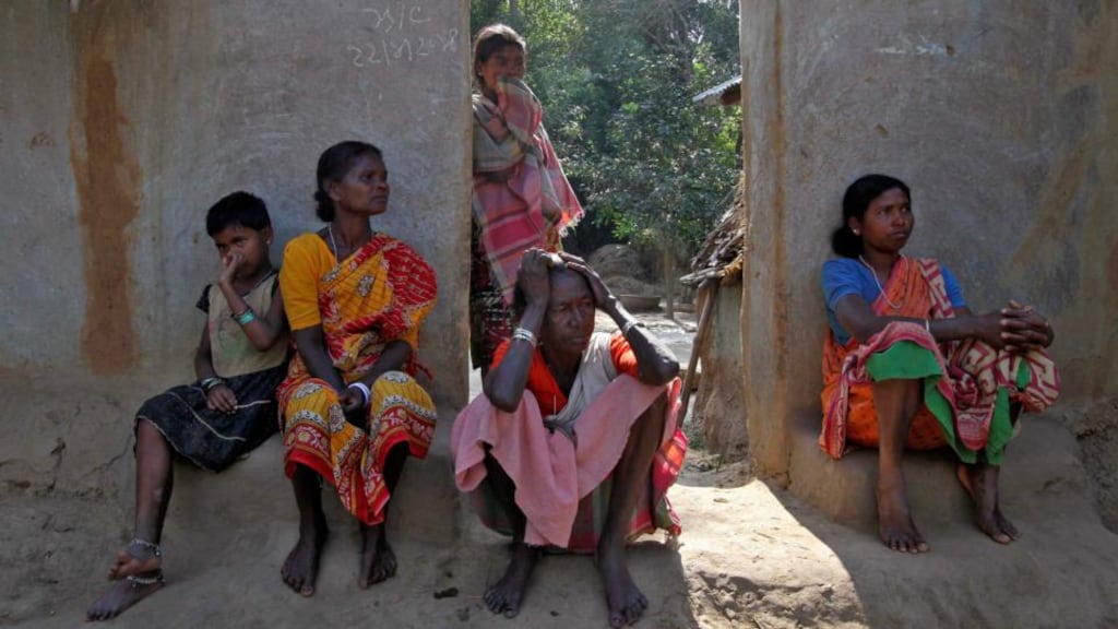 Villagers sit near the area where a woman was gang-raped in Birbhum district in the eastern Indian state of West Bengal Photograph: Reuters