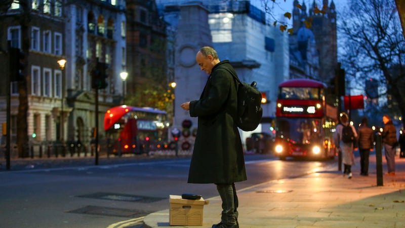 Dominic Cummings waits with a box of possessions on Whitehall after departing 10 Downing Street. Photographer: Hollie Adams/Bloomberg
