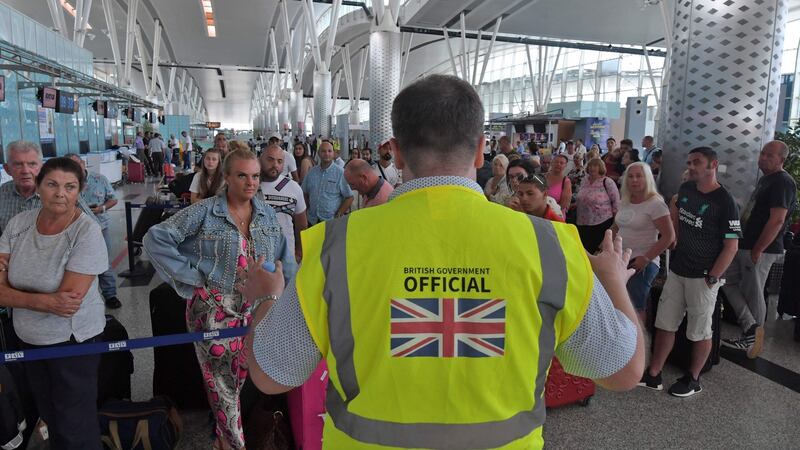 A British government official speaks to tourists flying with Thomas Cook, as they queue at the Enfidha International airport near Tunis on September 23rd. Photograph: Fethi Belaid/AFP