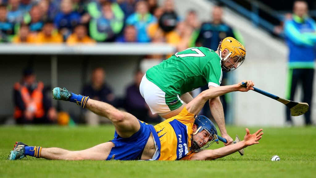 Limerick’s Richie English in action against Clare’s two-goal hero Shane O’Donnell at Semple Stadium. Photograph: Photograph: Cathal Noonan/Inpho