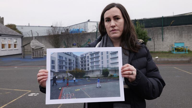 Principal Naomi Rousseau holds a computer-generated image of the proposed apartment block overlooking the school playground. Photograph: Laura Hutton