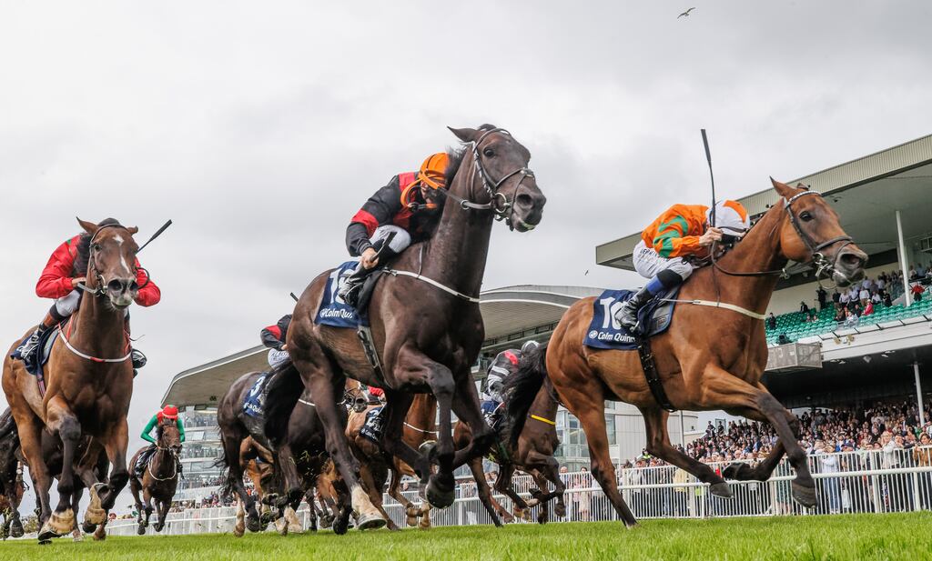 Chris Hayes on Coeur D'or (orange and green) wins by a head in front of No More Porter in the Colm Quinn BMW Mile on Day Two of the Galway Racing Festival in Ballybrit. Photograph: James Crombie/Inpho