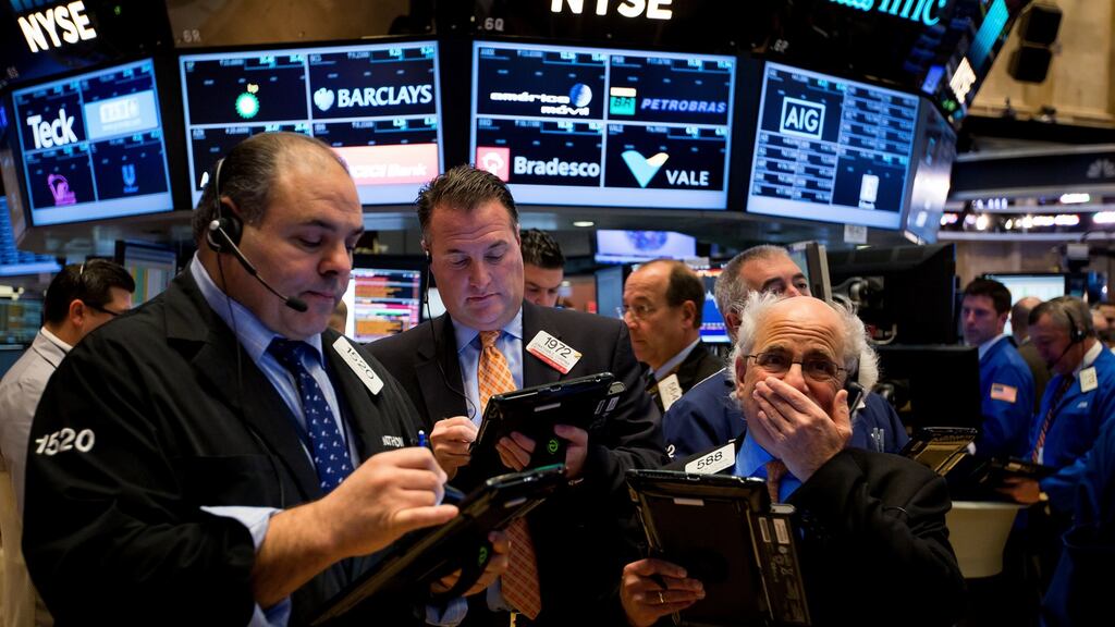 Traders work on the floor of the New York Stock Exchange:  US stocks rose from a six-week low amid an increase in deal activity as traders assessed the outlook for the presidential election and interest rates in the world’s largest economy. Photograph: Michael Nagle/Bloomberg