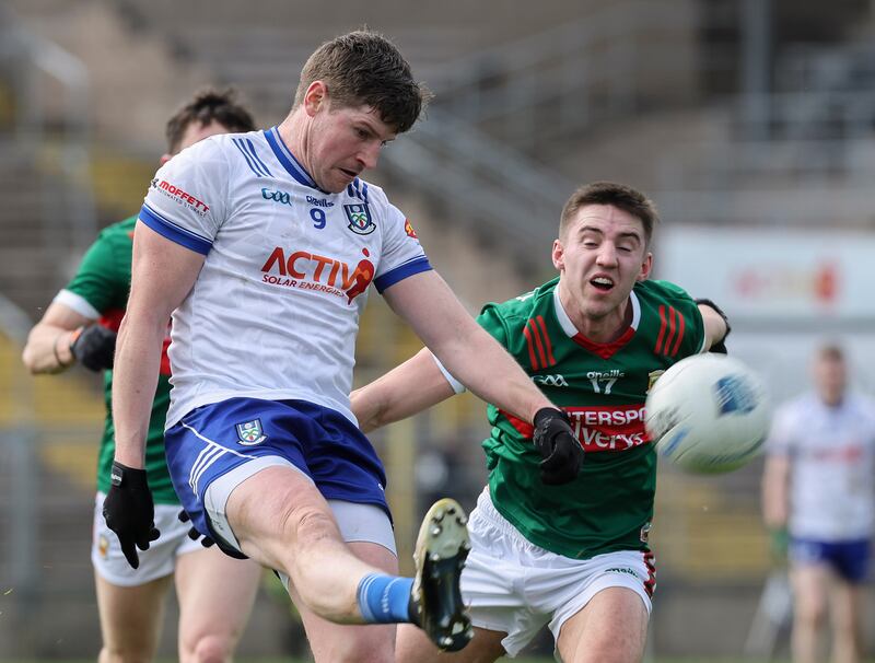 Monaghan's Darren Hughes kicks the ball as Conor McStay of Mayo closes in during a Division 1 match in 2024. Photograph: Lorraine O’Sullivan/Inpho
